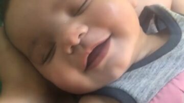Cute-toddler-mesmerizes-with-heartwarming-sleep-smile-Adorable.jpg