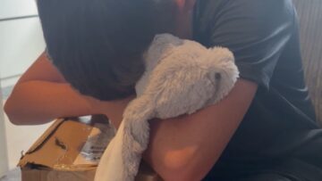 Heartfelt-Moment-Boy-Sobs-Clutching-Cuddly-Toy-with-Grandmas-Photo.jpg